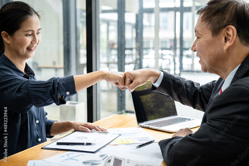 Poster business team is checking business document together and making a fist-bump after mission complete