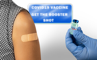 Vaccination clinic for covid 19 vaccine booster shot. A patient and the booster vaccine bottle....