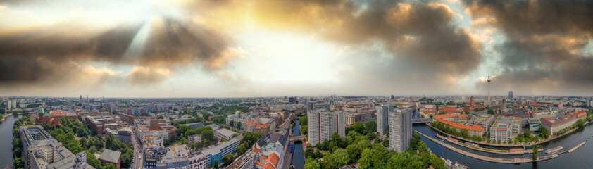 Panoramic aerial view of Berlin skyline at sunset with major city landmarks along Spree river, Germany from drone in summer season. © jovannig