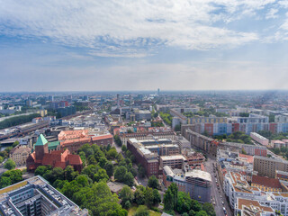 Fototapeta na wymiar Aerial view of Berlin cityscape from drone in summer season with city landmarks and blue sky, Germany