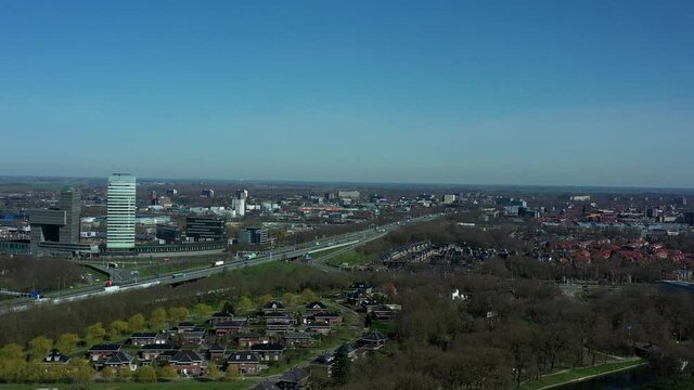 Aerial top view of a city in Holland, surrounded by houses, green trees and canal