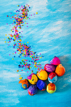 Creative and colorful easter eggs or carnaval eggshells placed with confetti traditional in latinamerica