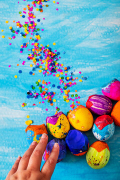 Creative and colorful easter eggs or carnaval eggshells placed with confetti traditional in latinamerica