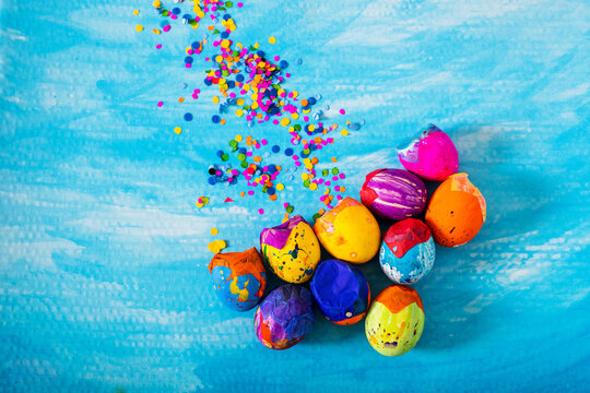 Creative and colorful easter eggs or carnaval eggshells placed with confetti traditional in latinamerica