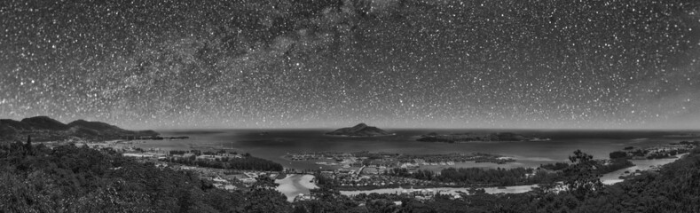 Panoramic aerial view of Eden Island and Mahe seascape from the hill on a starry night, Seychelles.