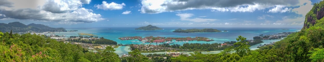 Fototapeta na wymiar MAHE', SEYCHELLES - SEPTEMBER 15, 2017: Panoramic aerial view of Eden Island and Mahe seascape from the hill at sunset.