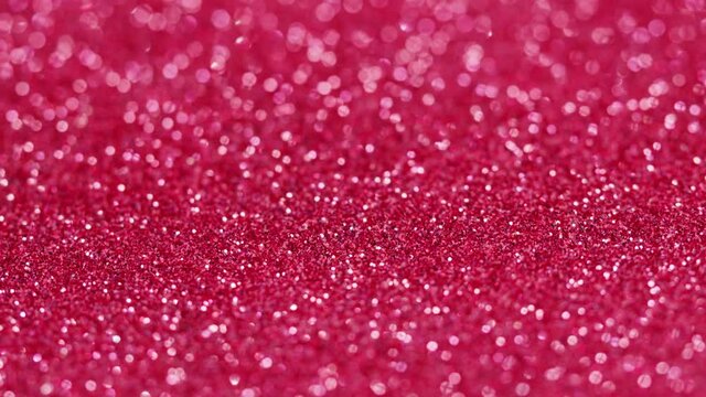 Pink glitter texture, bright shimmer close-up, shiny sparkle abstract background.