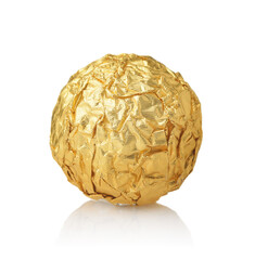 Single chocolate ball candy in gold foil wrapper - obrazy, fototapety, plakaty