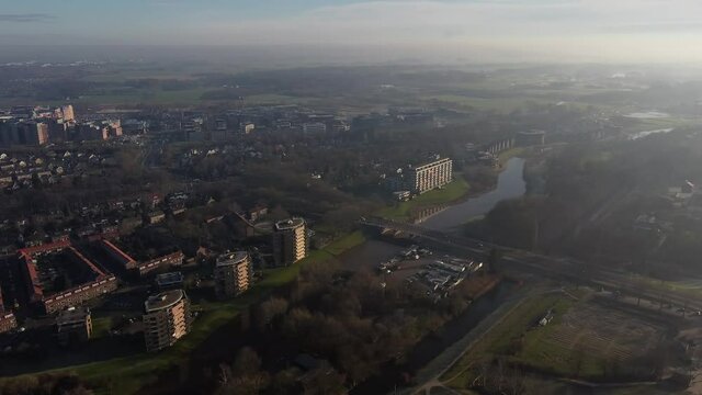 Aerial top view of a city in Holland, surrounded by houses, green trees and canal