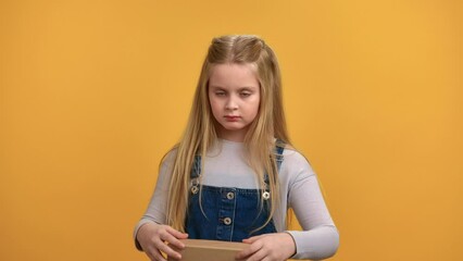 Portrait upset girl unsatisfied holiday present unpacking cardboard with no not wanted gesture