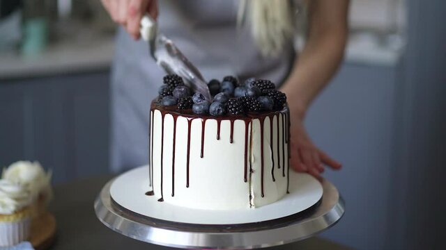 Young lovely woman pastry chef preparing birthday cake at home in kitchen Small business, homemade pastry chef Video HD Slow motion