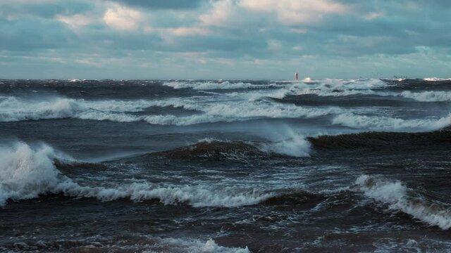 Stormy weather by the sea in Riga, Latvia. Huge waves crashing down the coast of Latvia during the storm.