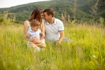 Fototapeta premium Young family having fun outdoors in the field