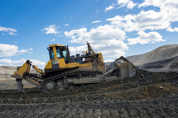A bulldozer works at a gold mining site.