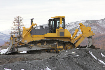 A bulldozer works at a gold mining site.