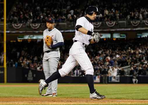 New York Yankees' Suzuki runs past Detroit Tigers third baseman Cabrera after hitting a two run home run during the ninth inning of Game 1 of their MLB ALCS playoff baseball series in New York
