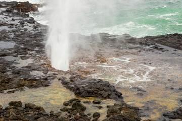 Spouting Horn Park on Kauai Island, Hawaii. Water being sprayed out of the Spouting Horn an old volcanic lava tube