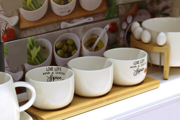 Stylish white kitchen utensils on the store counter