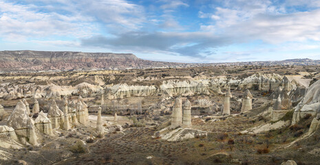 Fototapeta na wymiar Fairy chimneys in the Love Valley, rock formations near Goreme, Cappadocia, Turkey.