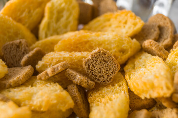 Salted rusk for beer close-up. Light snack with salt and pepper. Croutons from wheat and rye bread. Soft focus, abstract, food background