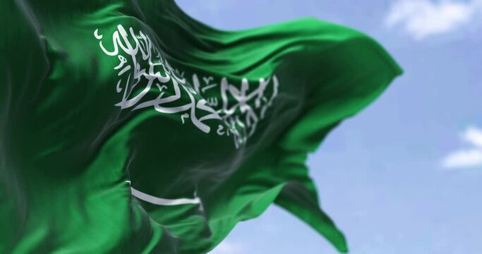 Detailed close up of the national flag of Saudi Arabia waving in the wind on a clear day