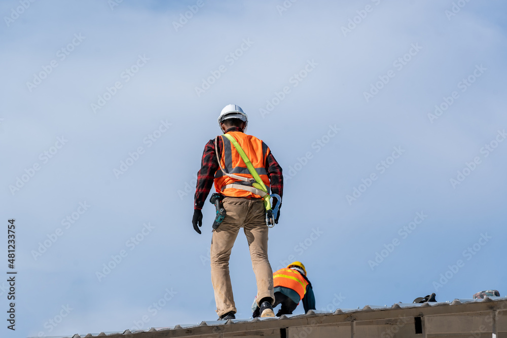 Aufkleber roofer worker installing new roof on top of the ,concept of residential building under construction.