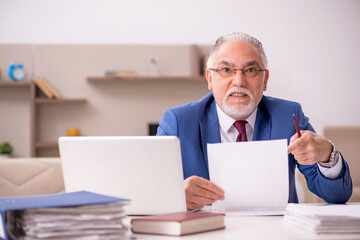 Old male teacher employee working from home during pandemic