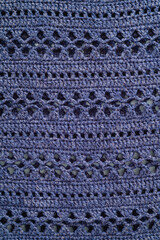Knitted texture. Blue chrocheted floral pattern.