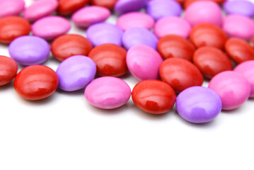 sugar coated pills on white background