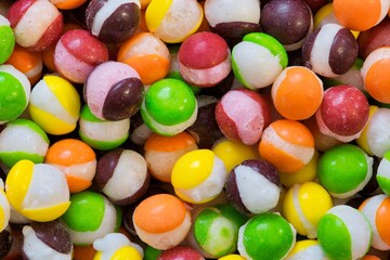 Freeze dried Skittles hard candy split centers, colorful sweet food treat background.