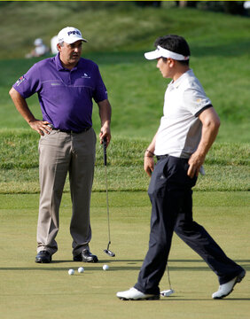 Argentina's Cabrera speaks with South Korea's Yang on the 13th green during a practice round for the 2013 U.S. Open golf championship in Ardmore