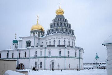 Fototapeta na wymiar ISTRA, RUSSIA - January 16, 2022, The Resurrection Cathedral of New Jerusalem Monastery was built according to the prototype - the Church of the Holy Sepulcher in Jerusalem. Snowfall