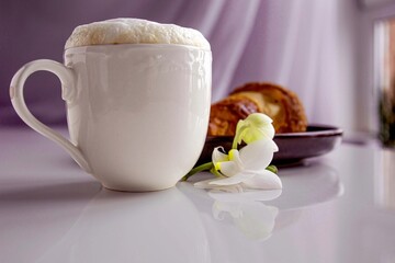 cup of coffee and cookies with flower orchid