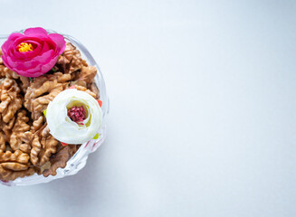 Peeled walnuts in a vase with flowers