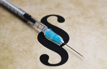Closeup of paragraph symbol with vaccination injection syringe - euthanasia assisted suicide dying concept - obrazy, fototapety, plakaty