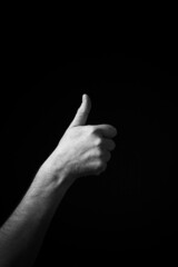 B+W image of hand demonstrating Chinese sign language letter A isolated against black background