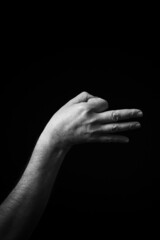 Fototapeta premium B+W image of hand demonstrating Chinese sign language letter E isolated against black background