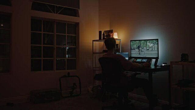 Professional color grading specialist edit raw ungraded files on computer. Editing and grading pro work from home on freelance basis. Late night editing of important project