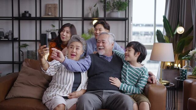 Asian big family taking selfie together at home.