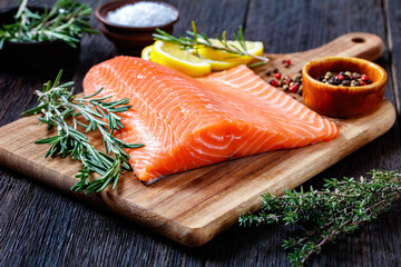 Fresh salmon fish fillet on wooden board