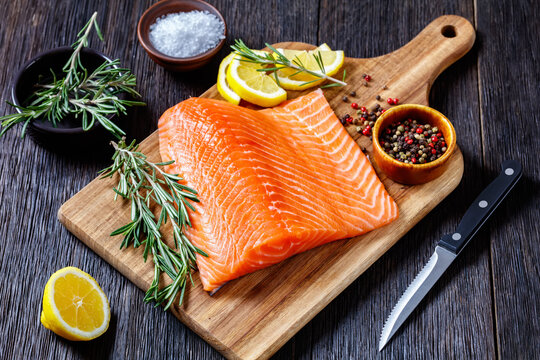 Fresh salmon fish fillet on wooden board