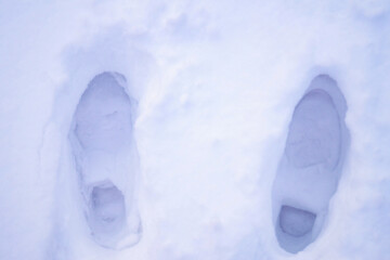 Human footprints in the white snow.