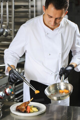 Chef Preparing Dish In Kitchen. Decorating Dish.