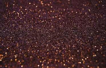 Purple de focused sparkle glitter background with golden particles close up 