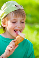 little boy eating ice cream in the park outdoors - 481242905