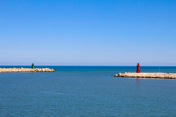 view of harbor entrance with green lighthouse and red lighthouse. Trani, Puglia, Italy