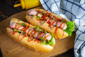 Delicious hot dog with ketchup and mustard on wooden background. Street food