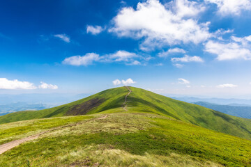 path through grassy mountain ridge. wonderful nature scenery of carpathians in dappled light. sunny weather with fluffy clouds on the sky. beautiful landscape of borzhava ridge, ukraine