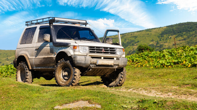kvasy, ukraine - AUG 22, 2020: off road ready 3 door mitsubishi pajero on the hill. dirty 4x4 vehicle with snorkel and mud tires. stunning adventures on a sunny summer day in mountains