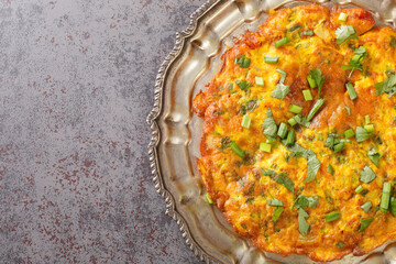 Stir Fried Veggie Omelet with mix vegetables. Indian Nepali Style Masala Omelette close up in the plate on the table. Horizontal top view from above